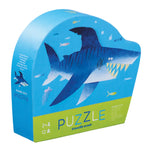 The Crocodile Creek Shark City 12 Piece Mini Puzzle features a cartoon shark design, enhances hand-eye coordination, is travel-friendly, and is suitable for ages 2 and up.