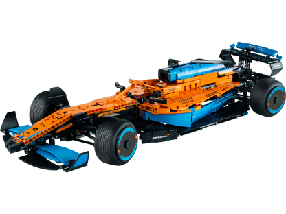 The LEGO® Technic™ McLaren Formula 1™ Race Car by Legos - Toyhouse features an orange, blue, and black design with intricate aerodynamic elements and branding decals, embodying speed and precision.