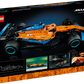 The LEGO® Technic™ McLaren Formula 1™ Race Car set from Legos - Toyhouse includes a vibrant orange and blue model car. The box highlights detailed views and features the iconic McLaren logo in the top right corner.