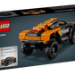 The LEGO® Technic™ NEOM McLaren Extreme E Race Car by Legos - Toyhouse is an orange and black pull-back toy car, with its box displayed from a rear three-quarter view.