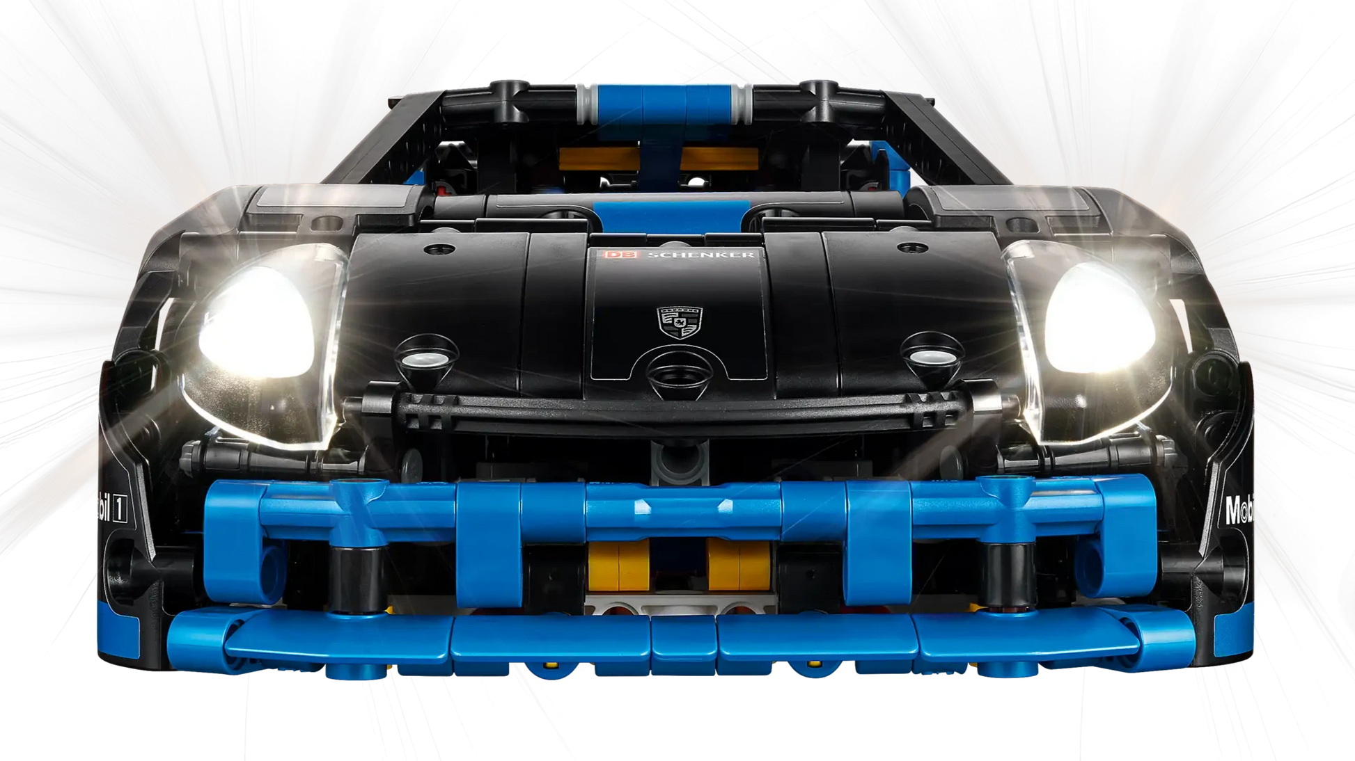 Front view of the LEGO® Technic™ Porsche GT4 e-Performance Race Car by Legos - Toyhouse, a black and blue remote-controlled model with headlights on, detailed grille, and Porsche badge on the hood, set against a white background.