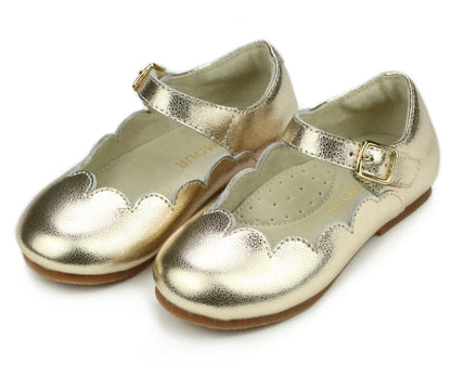 Check out the L'Amour Girls' Sonia Scalloped Flat by L'Amour Shoes: elegant children's shoes made from luxurious gold metallic Nappa leather. These delightful flats showcase scalloped edges and ankle straps with buckle closures, providing comfort with memory foam insoles–ideal for tiny feet seeking both style and support.