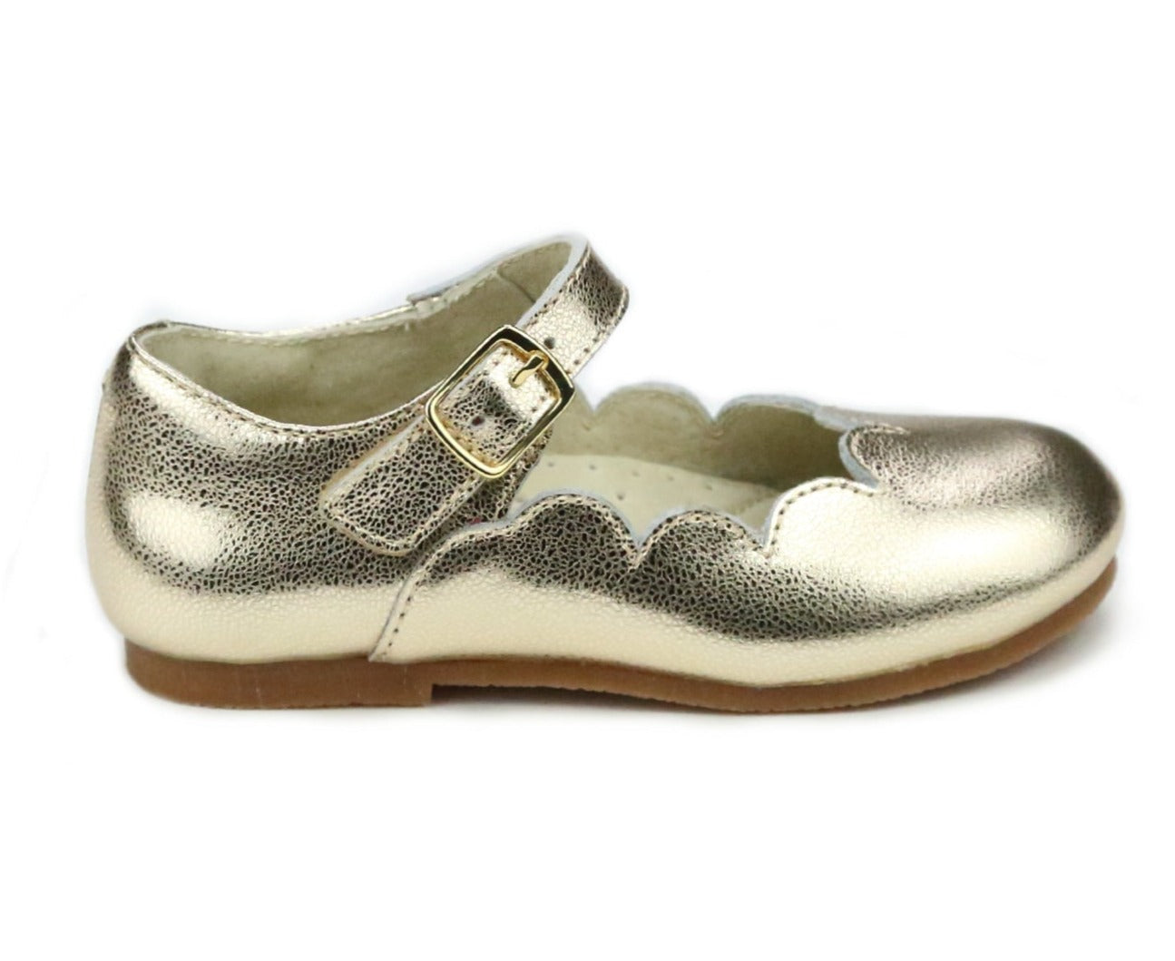 The L'Amour Girls' Sonia Scalloped Flat from L'Amour Shoes is a gold children's shoe made from soft Nappa leather, boasting a scalloped edge and buckle strap. It is designed for comfort with memory foam cushioning and is stylishly presented against a white background.