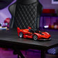 A LEGO® Technic™ Ferrari FXX K model by Legos - Toyhouse sits on a black desk in a modern room, with a black office chair and shelves in the background.