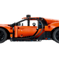 A side view of the LEGO® Technic™ Bugatti Chiron Pur Sport Hypercar by Legos - Toyhouse, featuring orange color, black wheels, and intricate details inspired by the iconic hypercar.