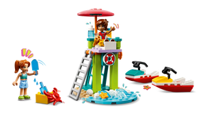 The LEGO® Friends Beach Water Scooter set from Legos - Toyhouse includes a lifeguard tower with a figure using binoculars, a crab, and a boat. Another figure is near a sandcastle with a spade and lifebuoy as the water scooter zooms past under an umbrella.