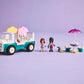 The LEGO® Friends Heartlake City Ice Cream Truck by Legos - Toyhouse includes two mini figures, a small dog, table with umbrella, and ice cream accessories—ideal for pretend play on a vibrant purple background.