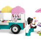 Spark creativity with the LEGO® Friends Heartlake City Ice Cream Truck by Legos - Toyhouse, featuring two mini-figures, a table with umbrella, ice cream accessories, a rabbit, and a green frog—ideal for imaginative pretend play!.