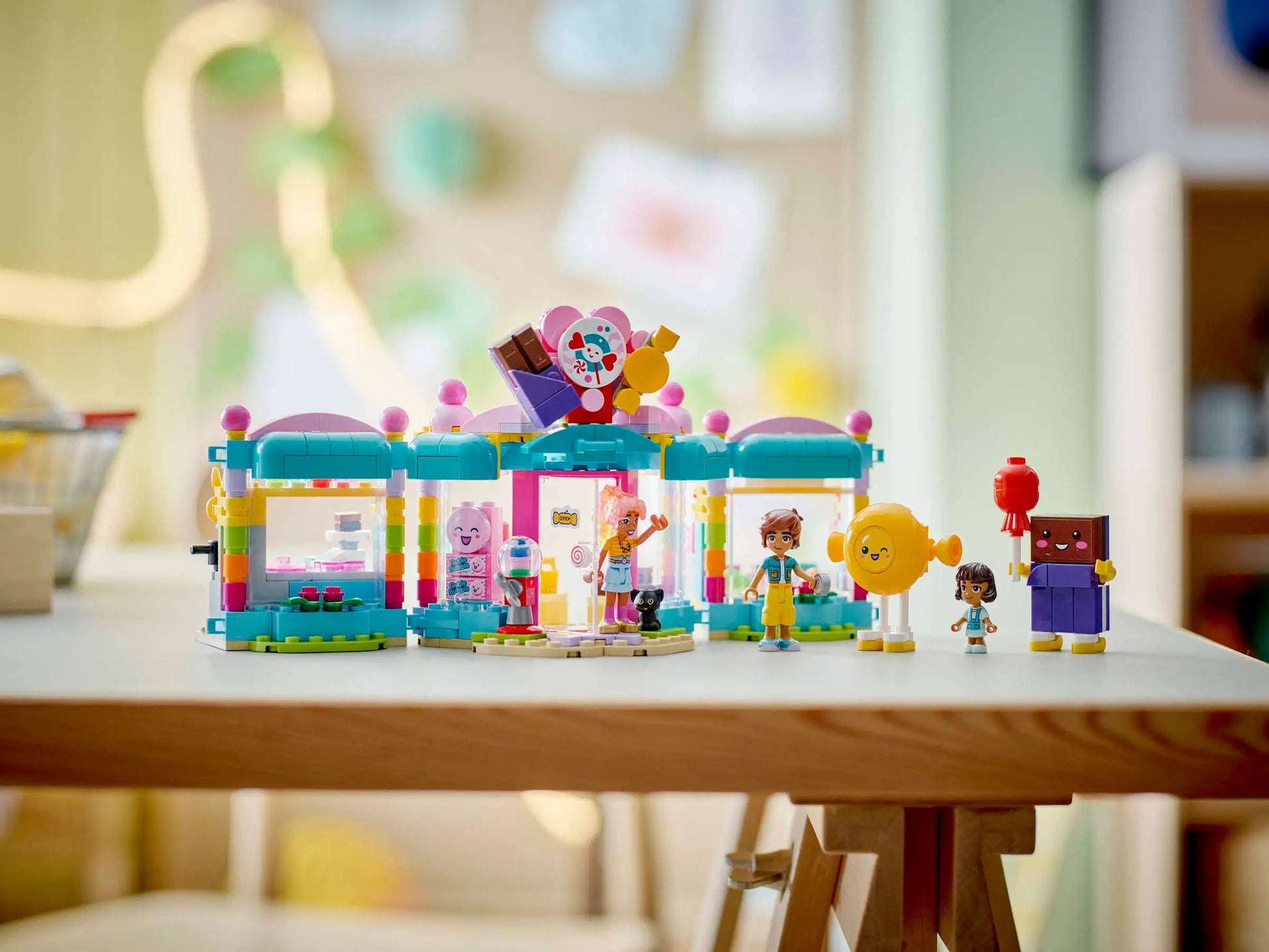 The LEGO® Friends Heartlake City Candy Store by Legos - Toyhouse features a colorful storefront, fun minifigures, and accessories—perfect for imaginative pretend play on any tabletop.