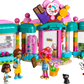 The LEGO® Friends Heartlake City Candy Store by Legos - Toyhouse includes three figures, a cat, candy and chocolate mascots, and candy accessories for colorful pretend play.