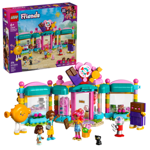 The LEGO® Friends Heartlake City Candy Store by Legos - Toyhouse includes a colorful bakery, four mini-doll figures, two large character figures, a black cat figure, and fun accessories; packaging appears in the background.