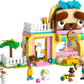 The LEGO® Friends Pet Accessories Shop by Legos - Toyhouse features a dog-shaped building, three figures, a dog, two cats, plus animal-care accessories and colorful decorations for imaginative pretend play.