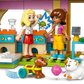 Two LEGO® Friends figures from the Legos - Toyhouse Pet Accessories Shop set enjoy animal-care pretend play with a dog, cat, playful accessories, and colorful furniture in the shop scene.