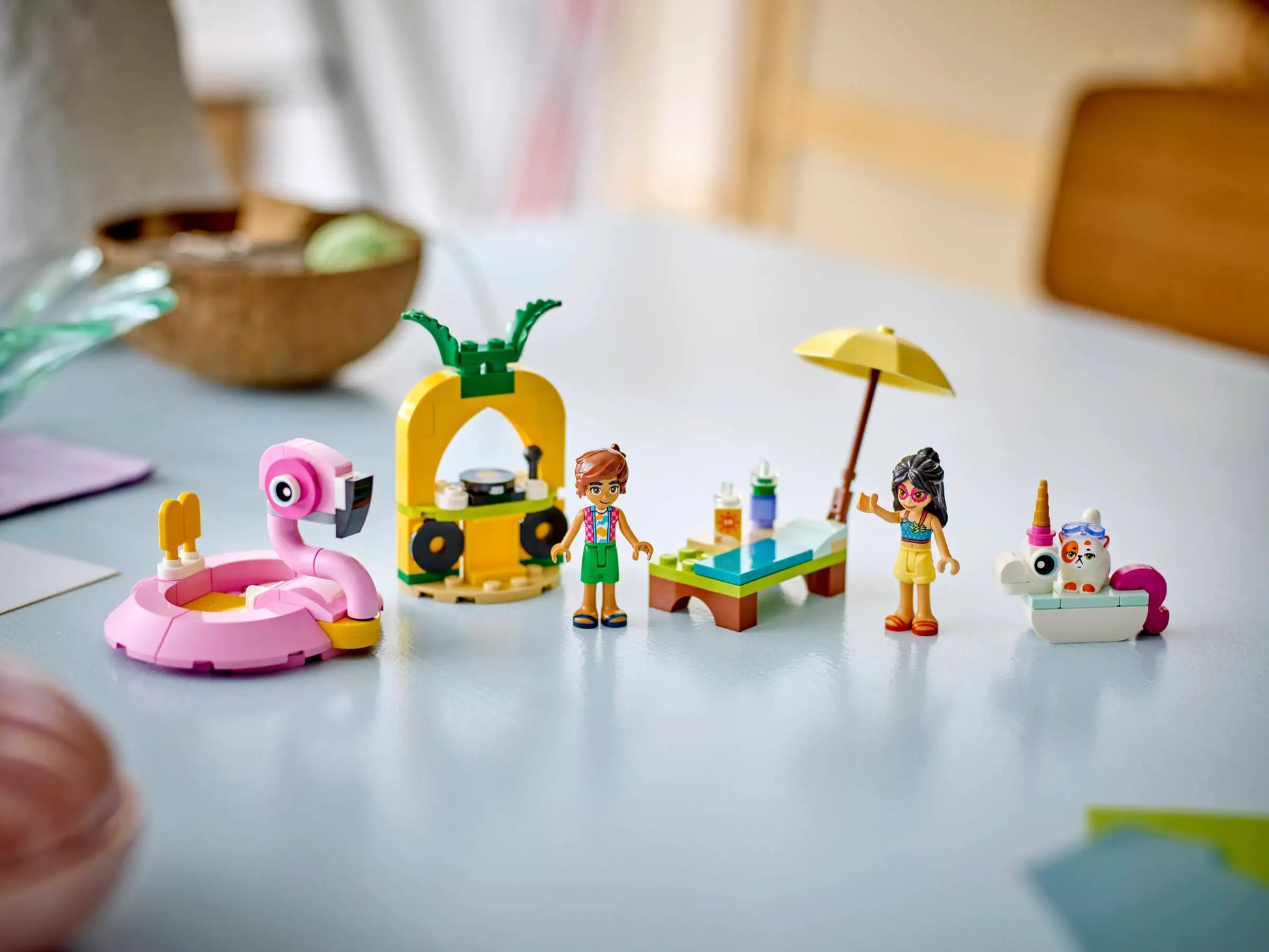 Host a fun LEGO® Friends Unicorn & Flamingo Pool Party by Legos - Toyhouse! Features mini-figures, a pink flamingo float, pineapple stand, drinks table, and an animal enjoying ice cream.