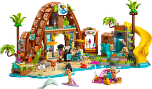 The LEGO® Friends Family Vacation Beach Resort by Legos - Toyhouse features minifigures, a resort building, palm trees, a yellow slide, surfboards, a dolphin, and fun beach accessories for kids.