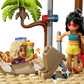 At the LEGO® Friends Family Vacation Beach Resort by Legos - Toyhouse, two figures have fun: one with a red bucket and shovel, and another buried in sand with just their head and arms showing—perfect for kids’ creative play!.