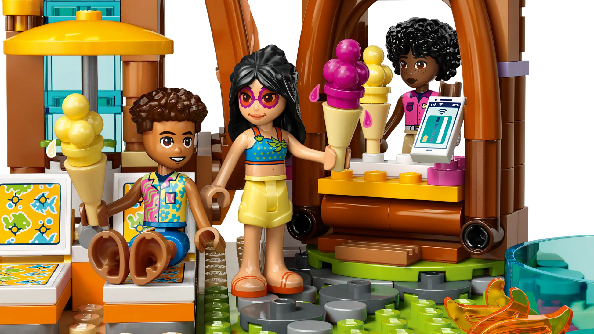 Bring summer fun to life with the LEGO® Friends Family Vacation Beach Resort by Legos - Toyhouse, featuring figures enjoying ice cream at a vibrant stand, plus colorful pieces that inspire creative building for kids.