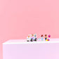 LEGO® Friends Unicorn Cake Delivery Car by Legos - Toyhouse, featuring two mini-figures, a dog, and accessories, displayed on a white surface with a pink background.