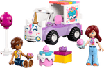 Two toy figures with desserts sit by the Legos - Toyhouse LEGO® Friends Unicorn Cake Delivery Car, featuring a unicorn design, cake, cupcake, and present—ideal for unicorn toy fans and creative building fun.