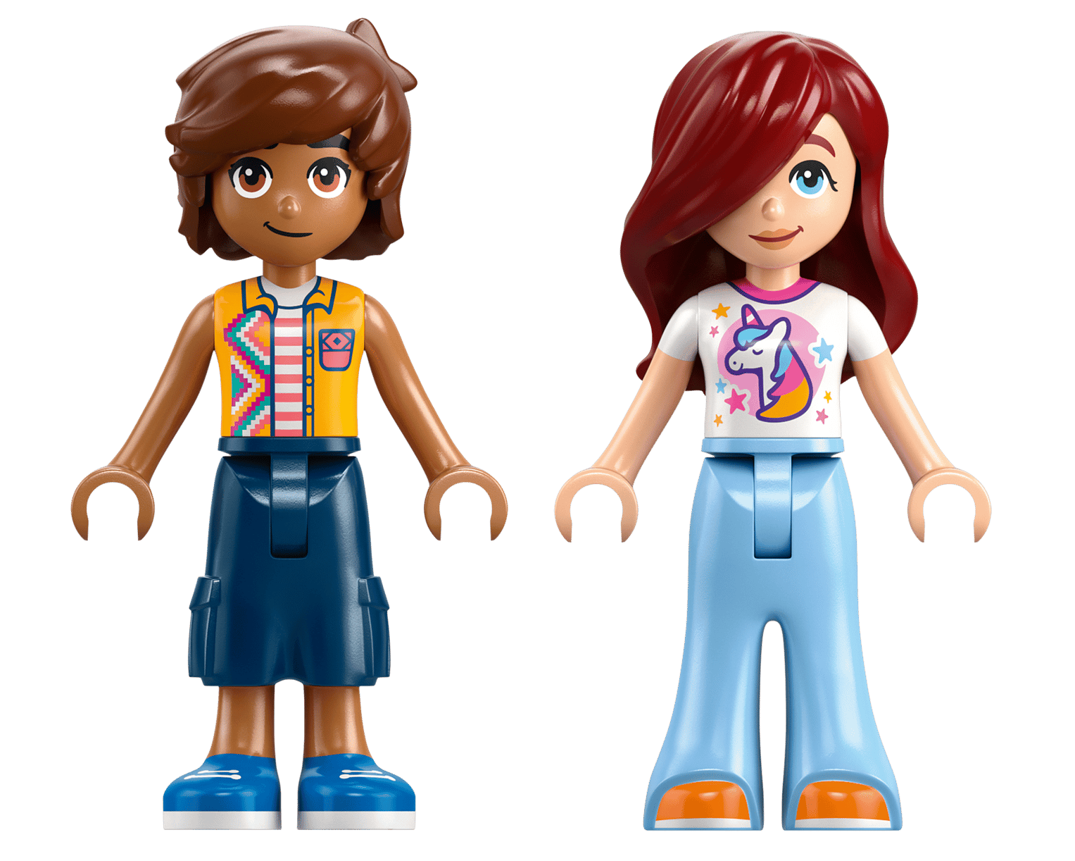 Two LEGO mini-dolls stand side by side; one with short brown hair and a patterned vest, the other with long red hair and a unicorn t-shirt—ideal for fans of unicorns and the Legos - Toyhouse LEGO® Friends Unicorn Cake Delivery Car set.