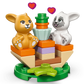 The LEGO® Friends Heartlake City Bunny Hotel by Legos - Toyhouse features two toy bunny figures on a colorful platform with a central plant and pink hearts, making it a charming animal care toy and perfect gift for kids.