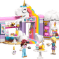 Discover the LEGO® Friends Unicorn Dream Café by Legos - Toyhouse, a vibrant unicorn bakery playset with two figures, desserts, tables, a tree, and charming pastel decorations.