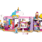 The LEGO® Friends Unicorn Dream Café by Legos - Toyhouse includes three mini-figures, fun accessories, a tree, and a seating area built from pink, blue, and white blocks—ideal for imaginative unicorn café adventures.