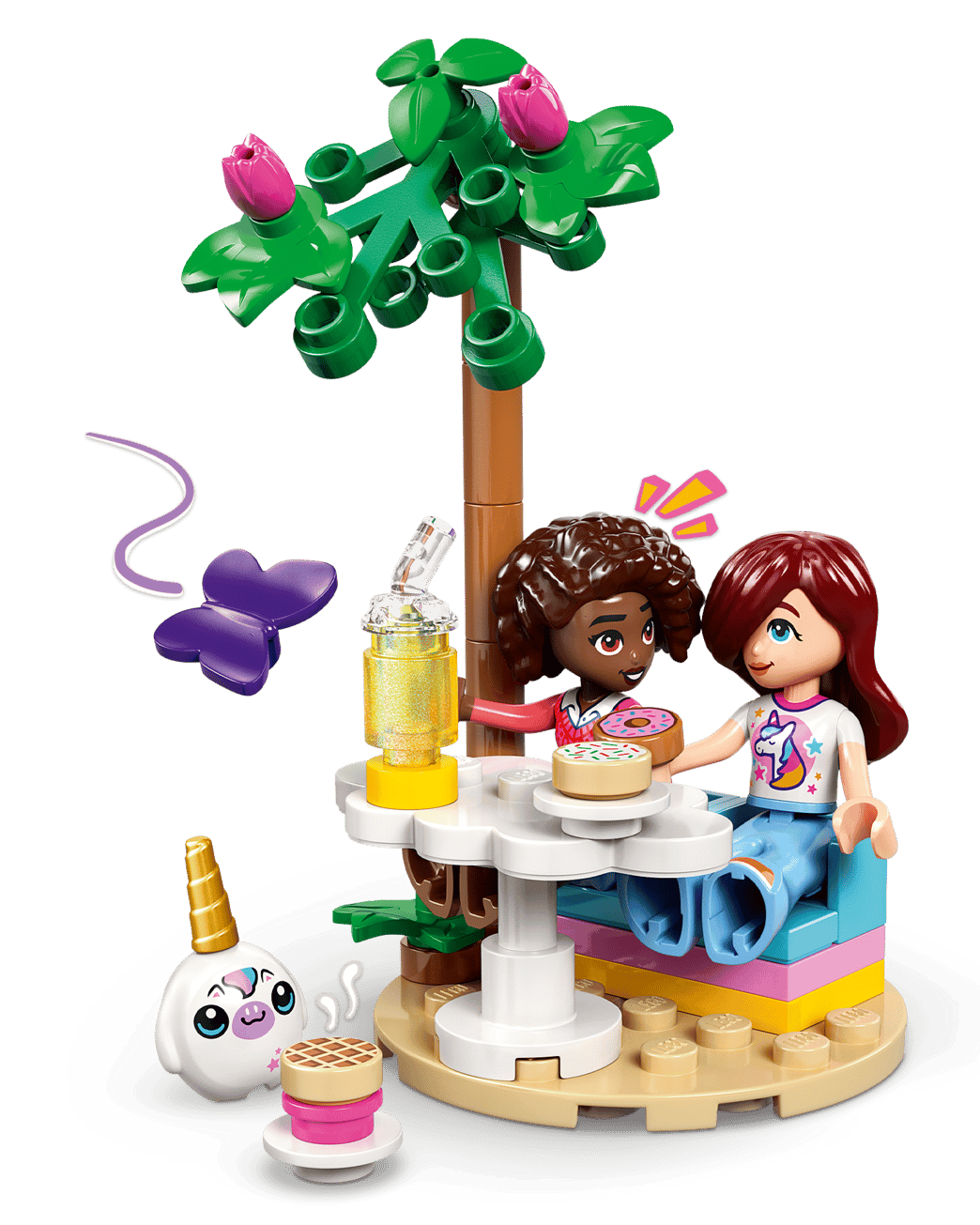 Two mini-dolls sit at a round outdoor table with food and drinks under a tree at the LEGO® Friends Unicorn Dream Café by Legos - Toyhouse, with a purple butterfly and unicorn café figure nearby.
