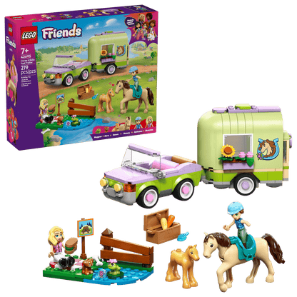 The LEGO® Friends Horse & Baby Foal Trailer by Legos - Toyhouse includes a green and purple car, two horse figures, two mini-dolls, and accessories—ideal for horse lovers; packaging shown in the background.