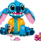 LEGO® Disney™ Stitch by Legos - Toyhouse: a fun buildable set featuring Stitch in a yellow shirt, sitting with a cup, plus pink flower and ice cream—an ideal Disney fan gift.