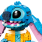 A close-up of the LEGO® Disney™ Stitch set by Legos - Toyhouse, featuring large black eyes, a blue nose, and a yellow floral shirt—a fun gift for any Disney fan.