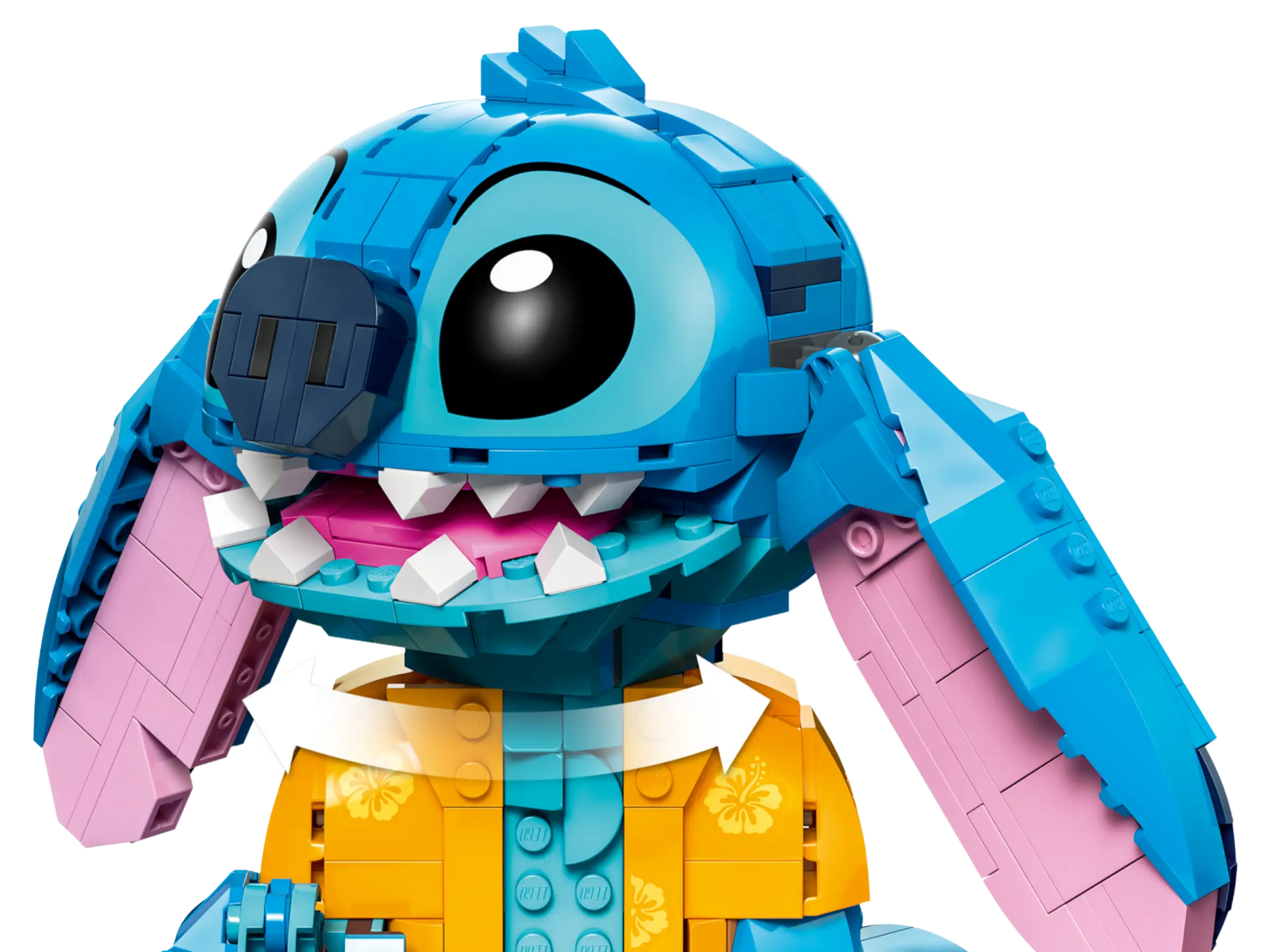 A close-up of the LEGO® Disney™ Stitch set by Legos - Toyhouse, featuring large black eyes, a blue nose, and a yellow floral shirt—a fun gift for any Disney fan.