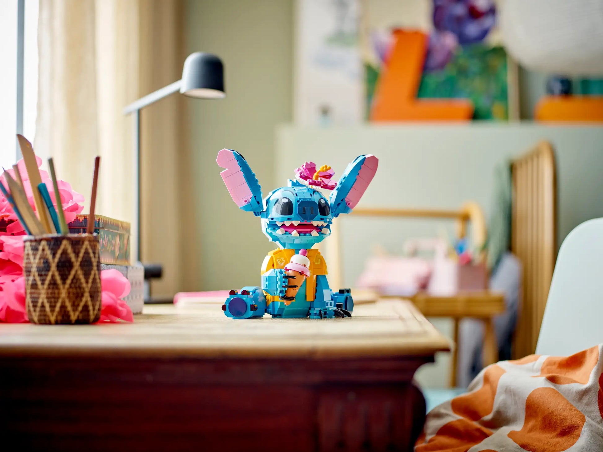 The LEGO® Disney™ Stitch set by Legos - Toyhouse features Stitch holding a flower and drink, making it a fun play-and-display gift for Disney fans—perfect for bright bedrooms or study spaces.