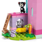Three toy cats surround a pink and purple building set, LEGO® Disney™ Minnie's Pet Hotel by Legos - Toyhouse, featuring a ladder, carrot, and green grassy base pieces.