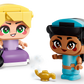 The LEGO® Disney™ Mini Jasmine & Rapunzel set by Legos - Toyhouse features two big-eyed figures—Jasmine in blue with a magic lamp, and Rapunzel in purple holding a pan—perfect for imaginative building play on a white background.
