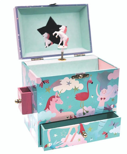 The Floss and Rock Rainbow Woodland Jewelry Box features unicorn and flamingo designs, whimsical illustrations, side and bottom drawers, a star-shaped mirror, and a spinning unicorn figurine inside.