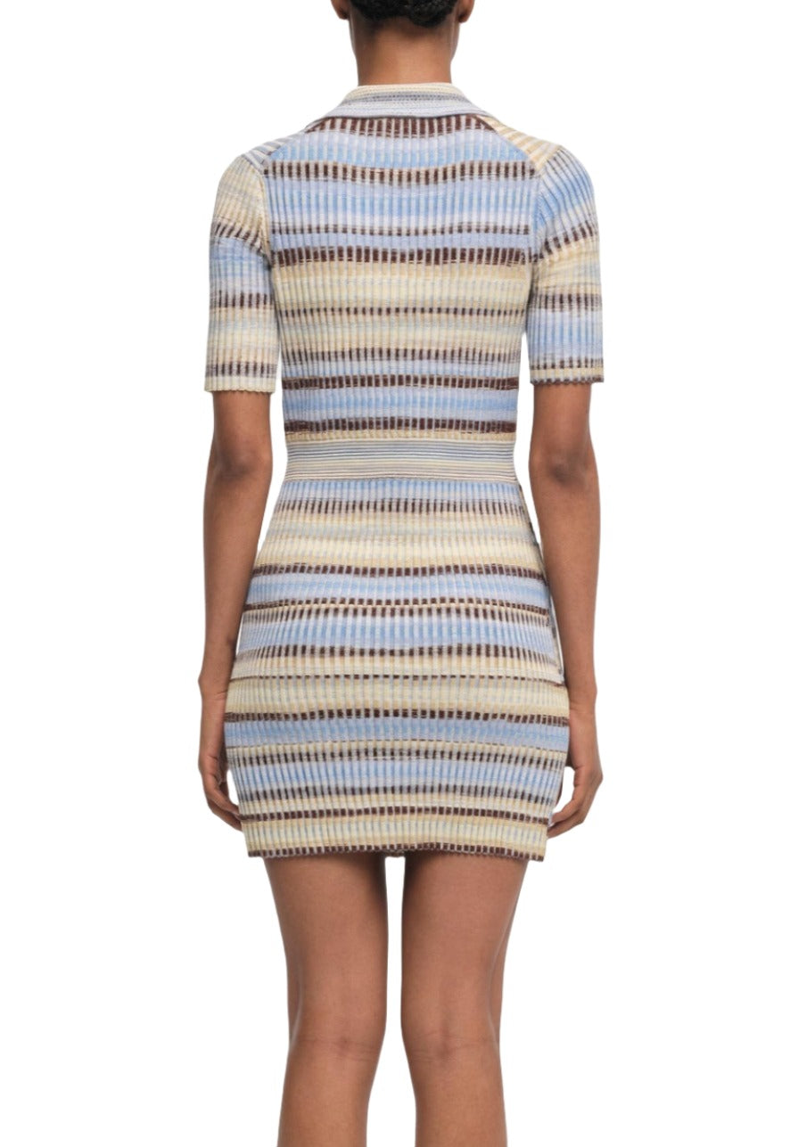 A person wearing the Simkhai Solana Dress, a short-sleeve, fitted piece with vibrant blue, beige, and brown horizontal stripes, seen from the back.