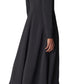 Someone in a stylish black Long Sleeve Crepe Shirt Dress from CO, paired with matching black boots, facing away.