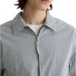 A person shown from the shoulders up wears a white t-shirt under a gray and white AG Jeans Philip Zip Jacket.