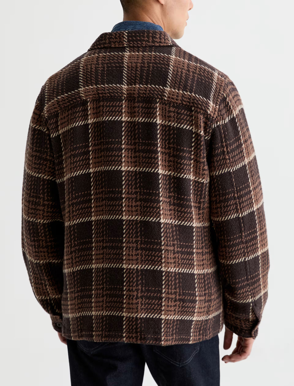 Back view of a person wearing a brown and tan houndstooth Grant Overshirt with a collar.