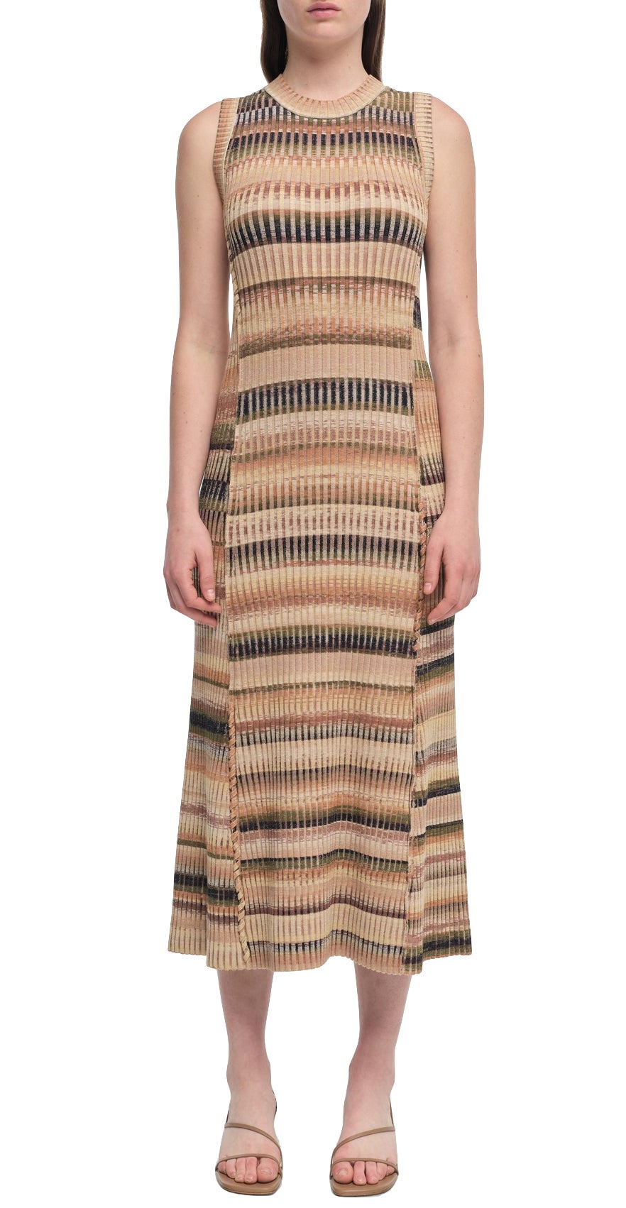 A person stands against a plain white background, showcasing the Simkhai Fairfax Dress, a sleeveless midi dress featuring an elegant striped pattern in earthy tones.