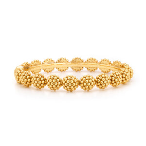 The Berry Eternity Hinged Bangle by Juliska Capucine De Wulf features textured gold-toned beads arranged in a continuous pattern around the band.