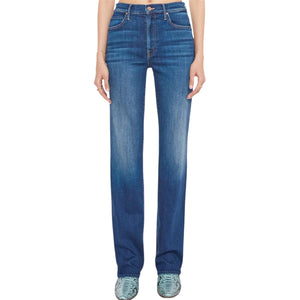 A person wearing Mother’s Kick It high-rise straight-leg jeans in mid-blue recycled stretch denim stands with arms by their sides, turquoise shoes peeking out.