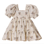 The Noralee Girls' Louella Dress features short puff sleeves, a cream floral print, a square neckline, and a charming tiered skirt for a vintage-inspired look.