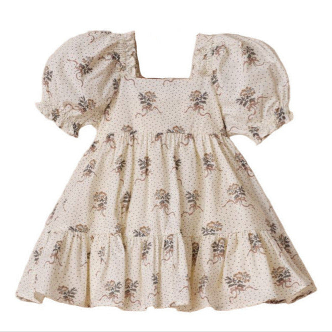 The Noralee Girls' Louella Dress features short puff sleeves, a cream floral print, a square neckline, and a charming tiered skirt for a vintage-inspired look.