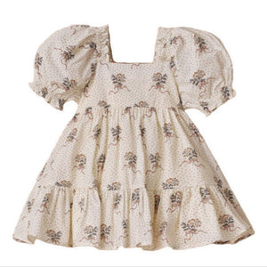 The Noralee Girls' Louella Dress features short puff sleeves, a cream floral print, a square neckline, and a charming tiered skirt for a vintage-inspired look.