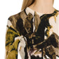 A person wearing the Jason Wu Collection Merino Wool Crewneck Sweater showcases its abstract green and brown brushstroke print, focusing on the upper body and part of the face in this unique piece from the Jason Wu Collection knitwear line.