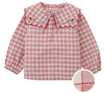 Gingersnaps Baby Girls’ Gracia Checkered Blouse features long sleeves and a red-and-white check pattern. The scalloped sailor collar is embellished with embroidered flowers. Inset highlights a detailed view of the storybook checks pattern and fabric texture.