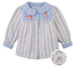 The Gingersnaps Baby Girls’ Hester Striped Floral Blouse features blue and white vertical stripes, a blue collar and cuffs, front button closure, and embroidered dogs playing with hoops on the chest. An inset highlights the textured fabric.