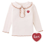 Dress your little one in the Baby Girls’ Gernaldine with Scalloped Collar from Gingersnaps—a charming long-sleeve cream shirt featuring a scalloped collar and cuffs, button placket, and a red heart embroidered applique reading “love” on the chest, perfect for toddlers.